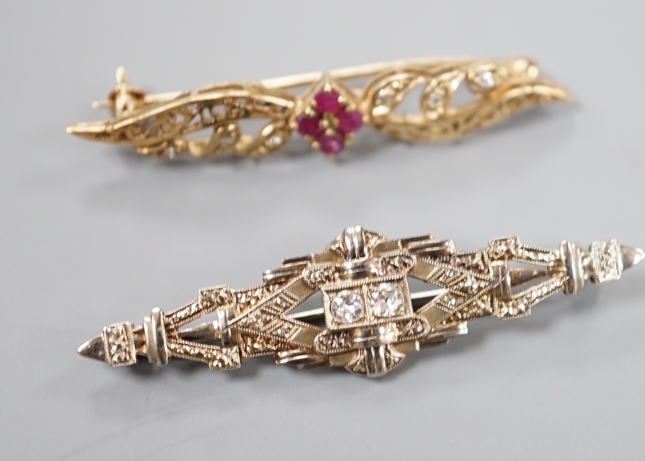 A modern 375, ruby and diamond chip set bar brooch, 44mm, gross 2.8 grams and an Austro Hungarian bar brooch.